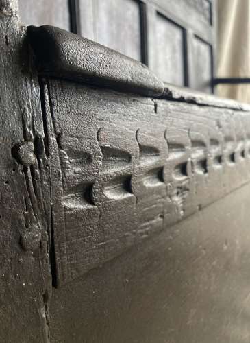 An antique and uncommon 17th century carved oak tavern box settle