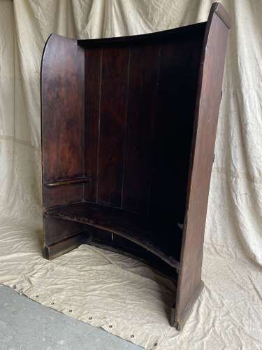 An antique George III pine barrel back tavern settle