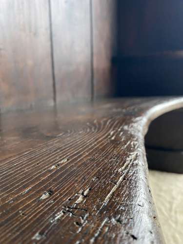 An antique George III pine barrel back tavern settle