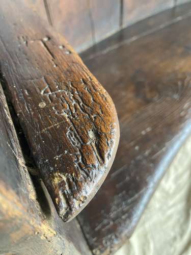 An antique George III pine barrel back tavern settle