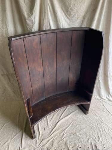 An antique George III pine barrel back tavern settle