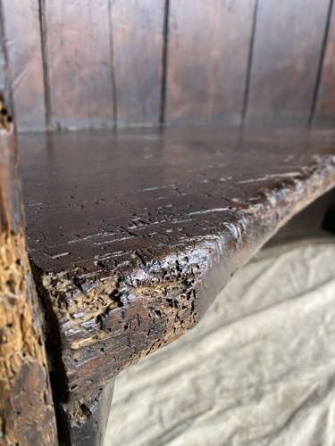 An antique George III pine barrel back tavern settle