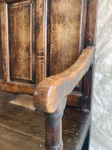 An antique late 18th century Welsh elm and pine settle bench.