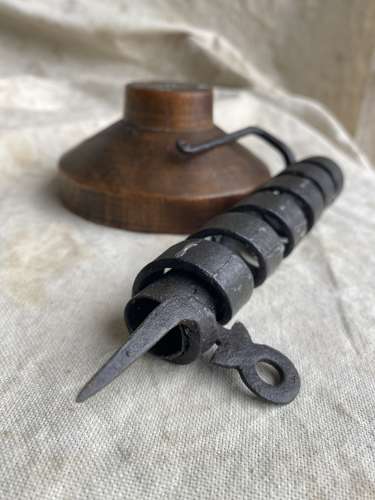 A French antique 19th century wrought iron cellar candlestick