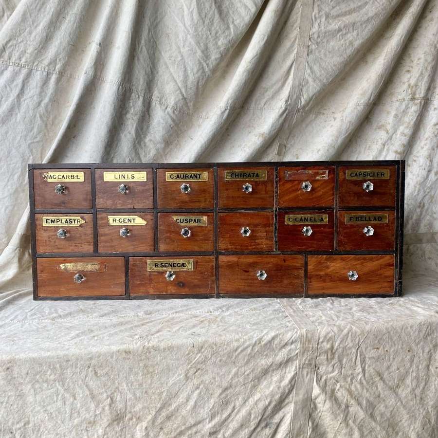 A bank of antique late Victorian apothecary shop drawers