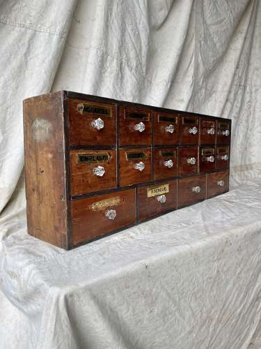 A bank of antique late Victorian apothecary shop drawers