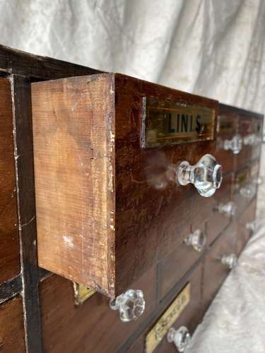 A bank of antique late Victorian apothecary shop drawers