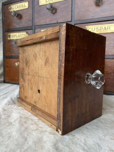 A bank of antique late Victorian apothecary shop drawers