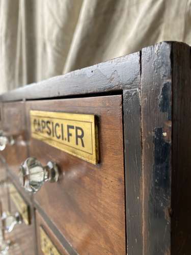 A bank of antique late Victorian apothecary shop drawers