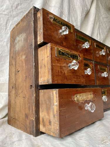 A bank of antique late Victorian apothecary shop drawers