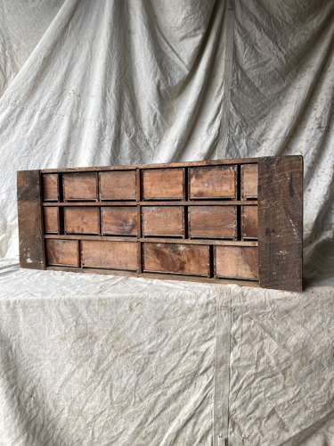 A bank of antique late Victorian apothecary shop drawers