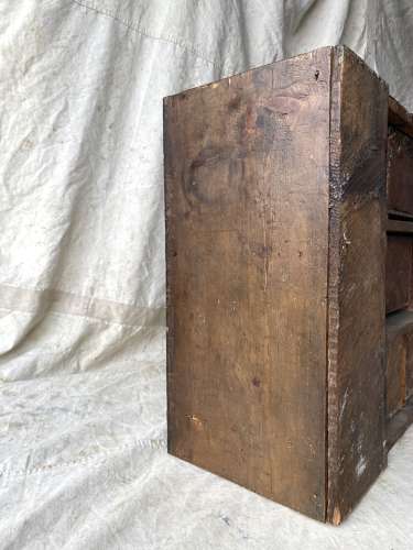 A bank of antique late Victorian apothecary shop drawers