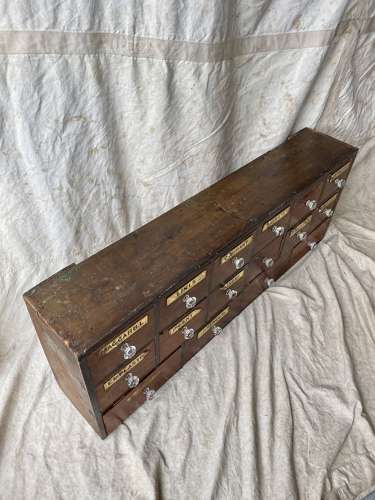 A bank of antique late Victorian apothecary shop drawers