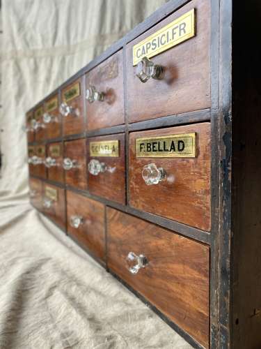 A bank of antique late Victorian apothecary shop drawers