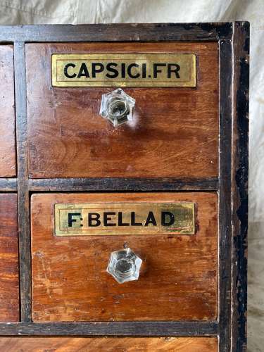 A bank of antique late Victorian apothecary shop drawers