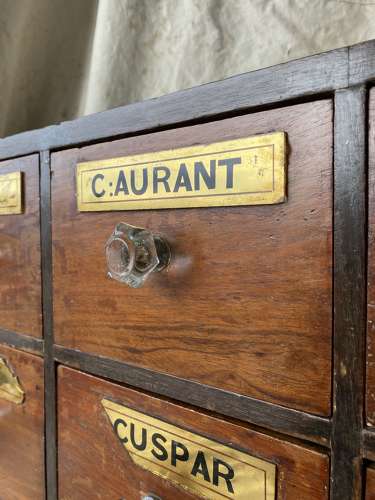 A bank of antique late Victorian apothecary shop drawers