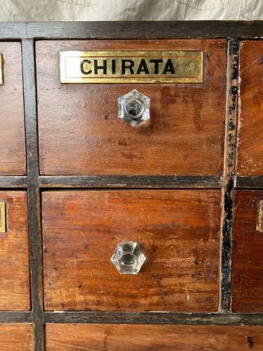 A bank of antique late Victorian apothecary shop drawers