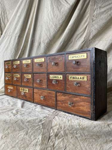 A bank of antique late Victorian apothecary shop drawers
