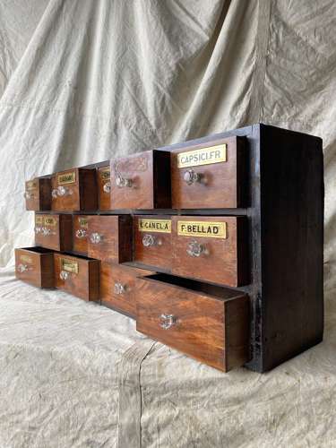 A bank of antique late Victorian apothecary shop drawers