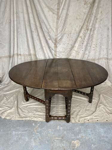 A large antique 18th century English oak gateleg table