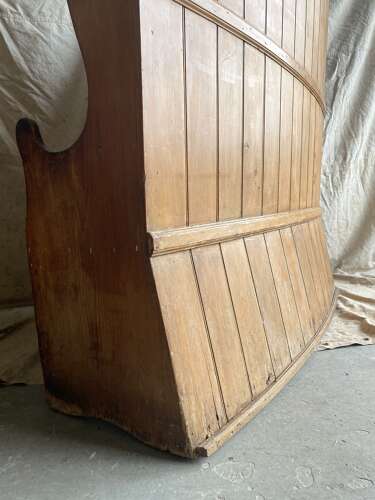 An antique George III pine barrel back tavern settle