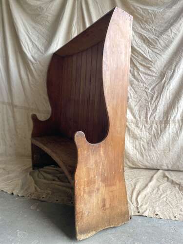 An antique George III pine barrel back tavern settle