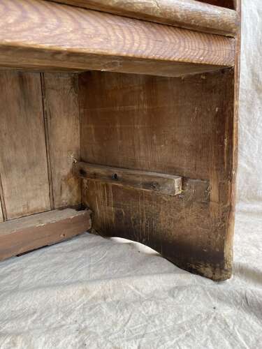 An antique George III pine barrel back tavern settle
