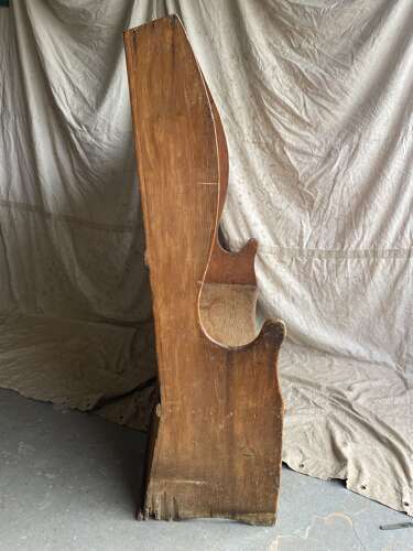 An antique George III pine barrel back tavern settle