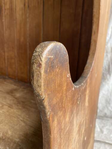 An antique George III pine barrel back tavern settle