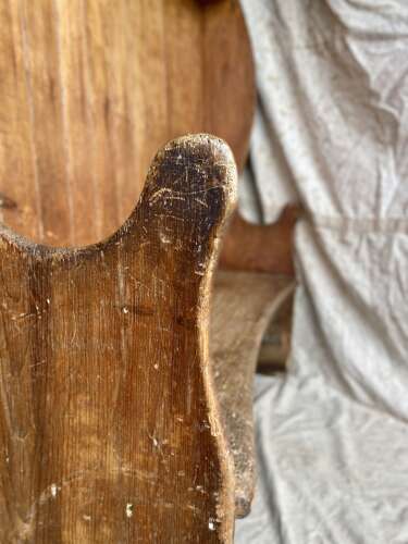 An antique George III pine barrel back tavern settle