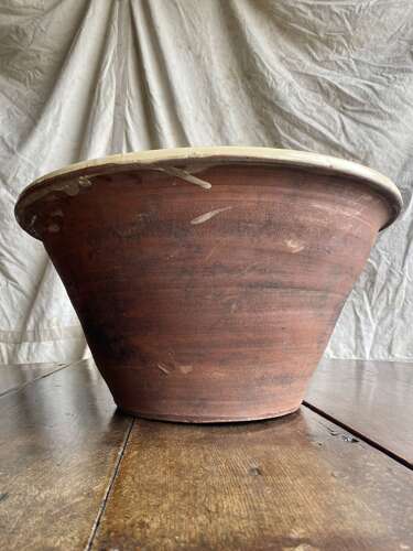 A large antique late 19th century Welsh glazed earthenware dairy bowl