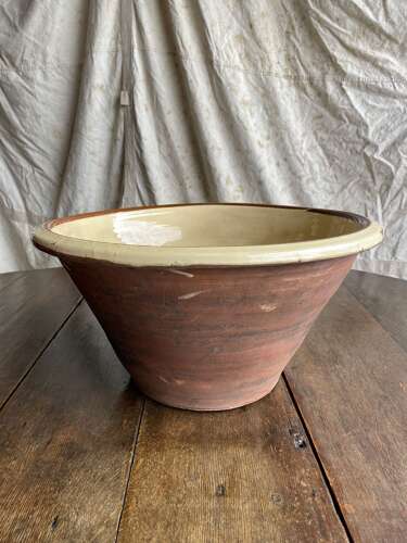 A large antique late 19th century Welsh glazed earthenware dairy bowl