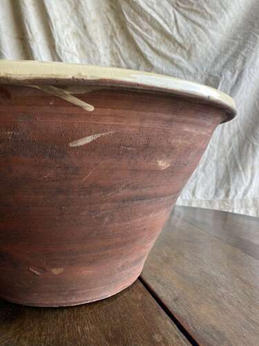A large antique late 19th century Welsh glazed earthenware dairy bowl