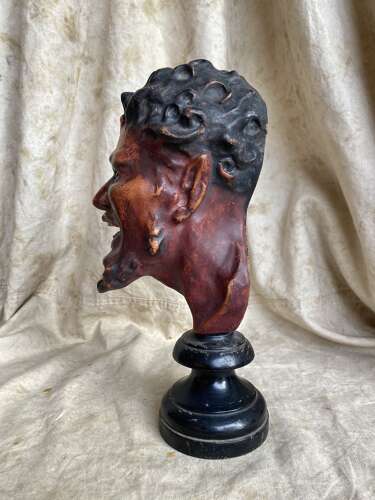 An antique late 19th century French plaster bust of a Faun or a Satyr