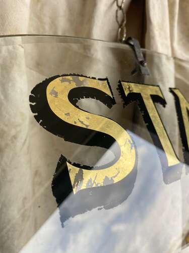 An antique early 20th century bevelled edge oval glass theatre sign