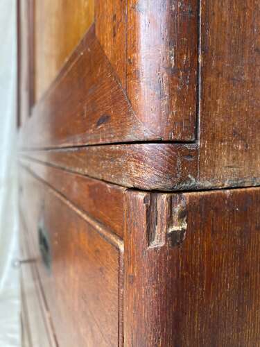 An antique 19th century three section teak campaign chest on chest with cupboard