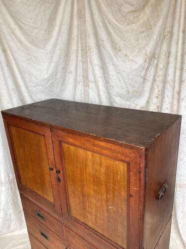 An antique 19th century three section teak campaign chest on chest with cupboard