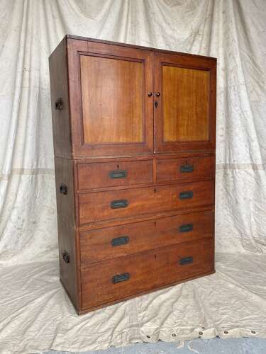 An antique 19th century three section teak campaign chest on chest with cupboard