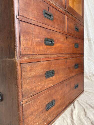 An antique 19th century three section teak campaign chest on chest with cupboard