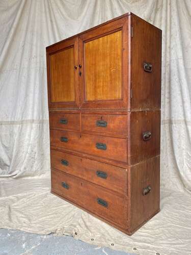 An antique 19th century three section teak campaign chest on chest with cupboard