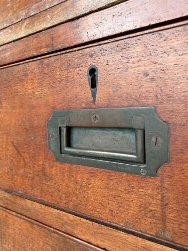 An antique 19th century three section teak campaign chest on chest with cupboard
