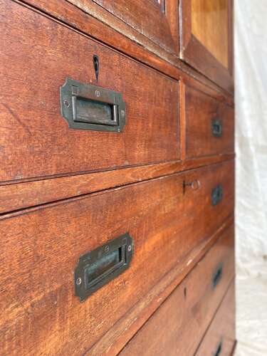 An antique 19th century three section teak campaign chest on chest with cupboard