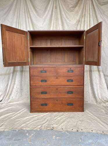 An antique 19th century three section teak campaign chest on chest with cupboard