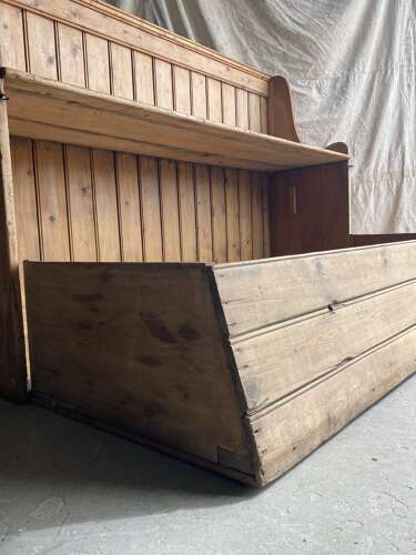 A rare antique 19th century vernacular pine Irish settle bed