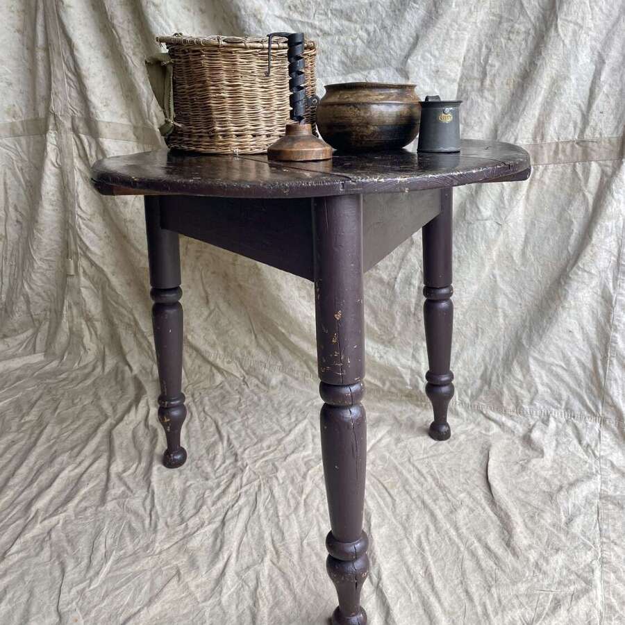 An antique 19th century pine cricket table