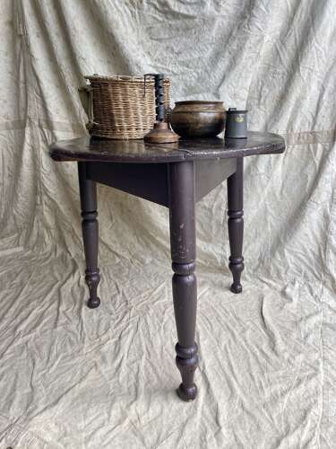 An antique 19th century pine cricket table