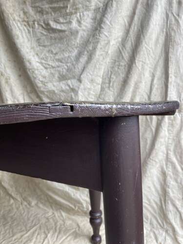 An antique 19th century pine cricket table