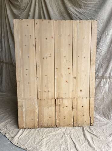 An antique early 19th century West Country pine and elm panel back settle