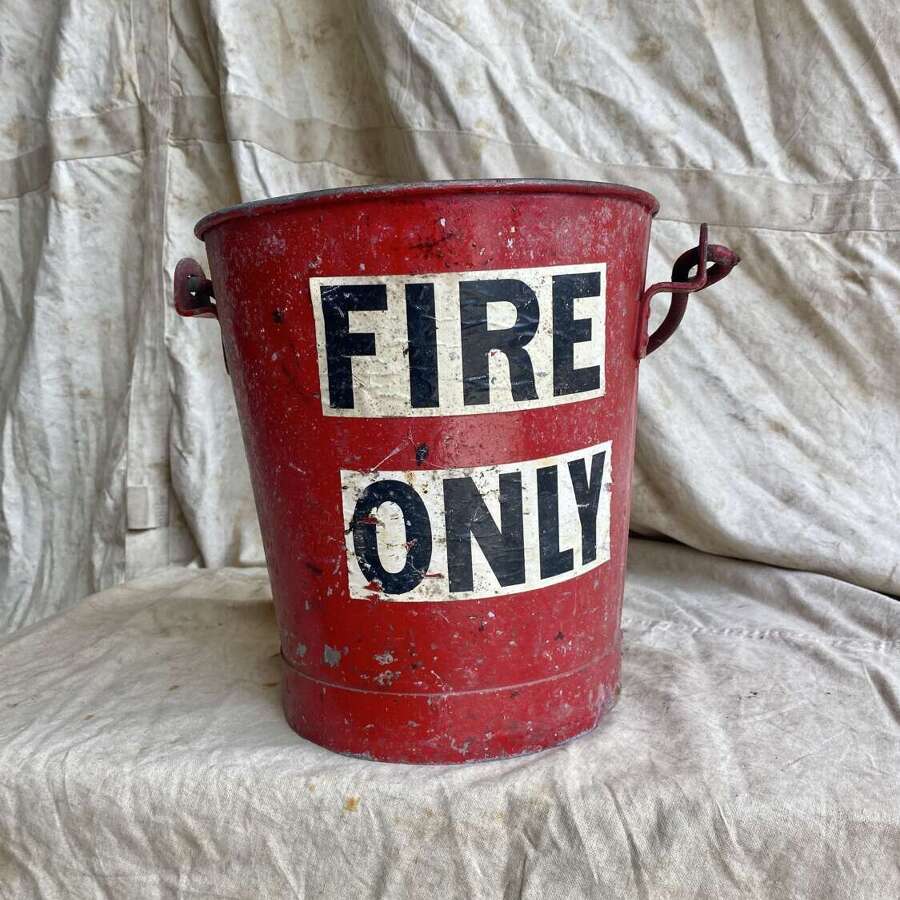 A vintage 1950s salvaged painted red fire bucket