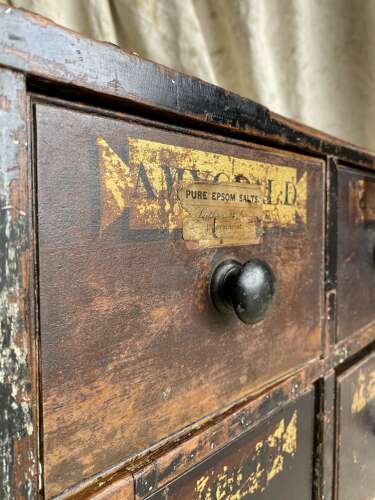 A bank of antique early 19th century mahogany and pine apothecary drawers